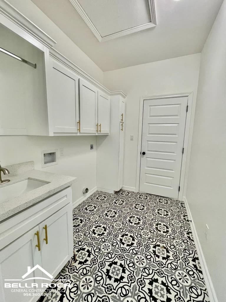 Custom laundry room with patterned tile flooring