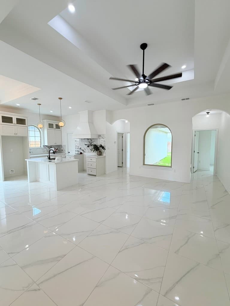 Open-concept kitchen and living space with marble floors