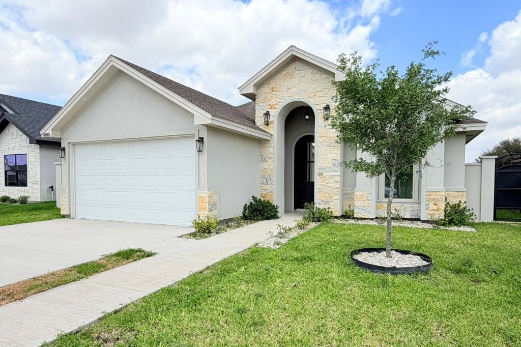 Residential exterior with stone veneer and arched entry